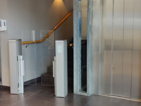 Modern interior with glass partition and wooden handrail